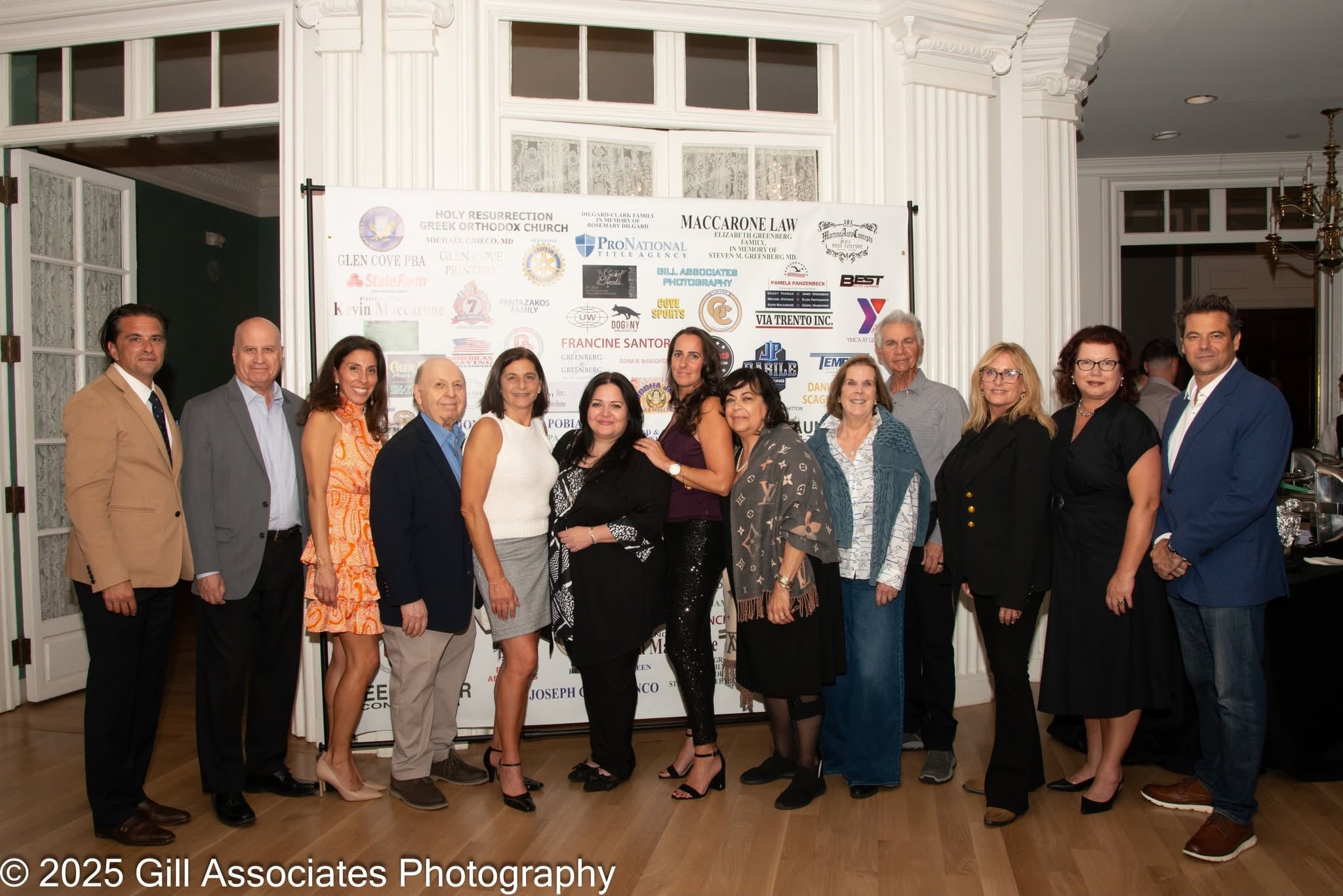 Board members posing together in front of the event sponsor backdrop at Evening of Tastings